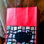 Mewsette on the Afghan gift bag, red.