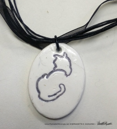 "Back to Front" pendant, 1" x 1.5" oval on multi-strand cord.
