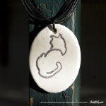 "Back to Front" pendant, 1" x 1.5" oval on multi-strand cord.