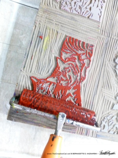 rolling ink onto linoleum block