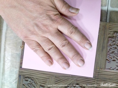 pressing the paper onto the linoleum block
