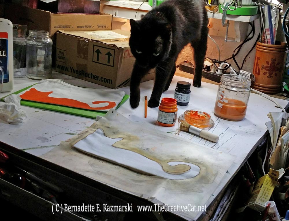 Mimi pawsonalizes a bag.