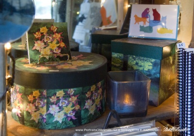 The green display with keepsake boxes, tiles, votives, and hand-printed note cards.