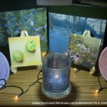 The blue and green display including keepsake boxes, tiles, decorative dishes and votives.