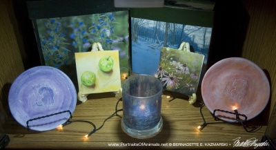 The blue and green display including keepsake boxes, tiles, decorative dishes and votives.