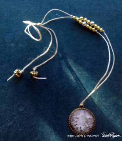 Roots cabochon with hemp cord and beads.