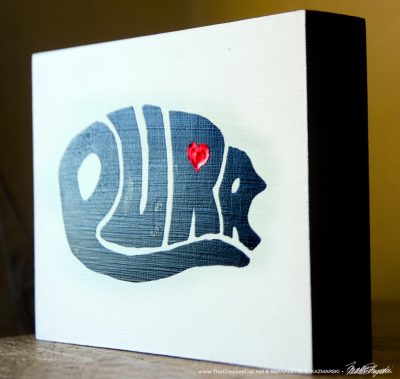 purr design on wood block