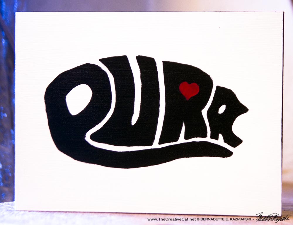 purr design on wood block