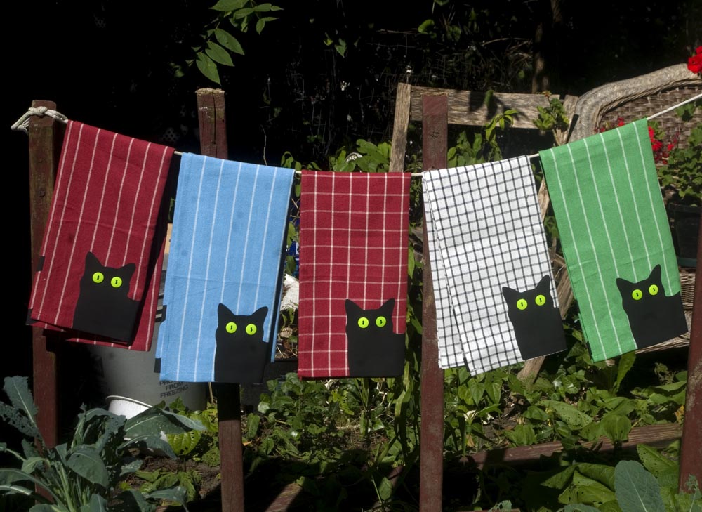 Selection of Bella! dishtowels with large pattern on various color/patterned towels.